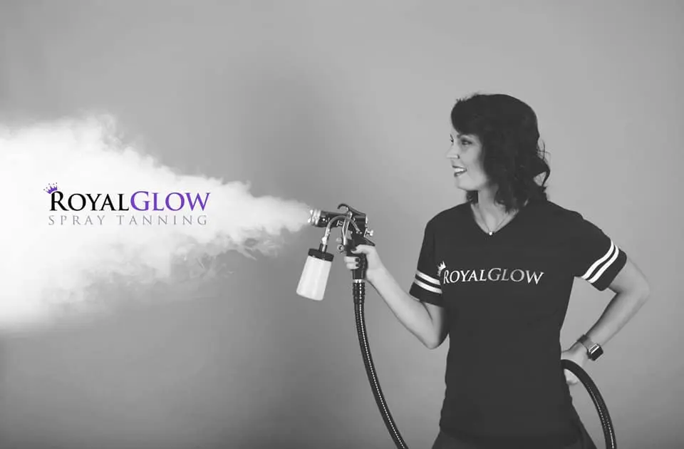 Professional airbrush spray tan application by hand at Royal Glow Beauty in Boardman Ohio