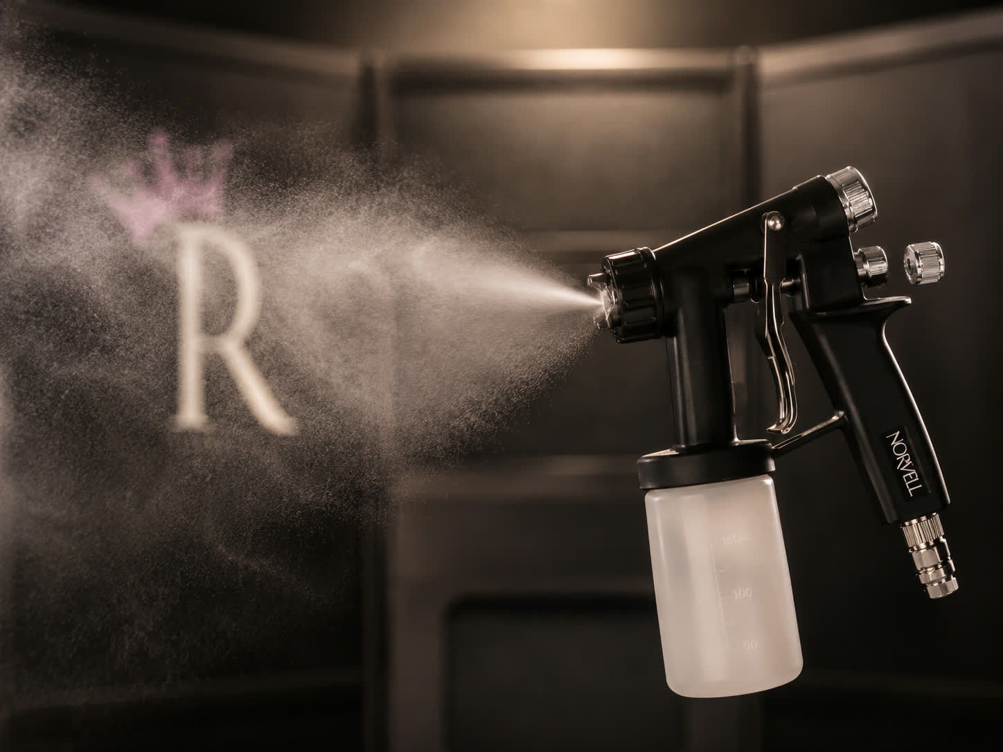 Norvell airbrush gun applying Royal Glow Hydration Lock finishing mist — the post-tan moisturizing spray tan add-on offered at Royal Glow Beauty and Esthetics in Boardman, Ohio